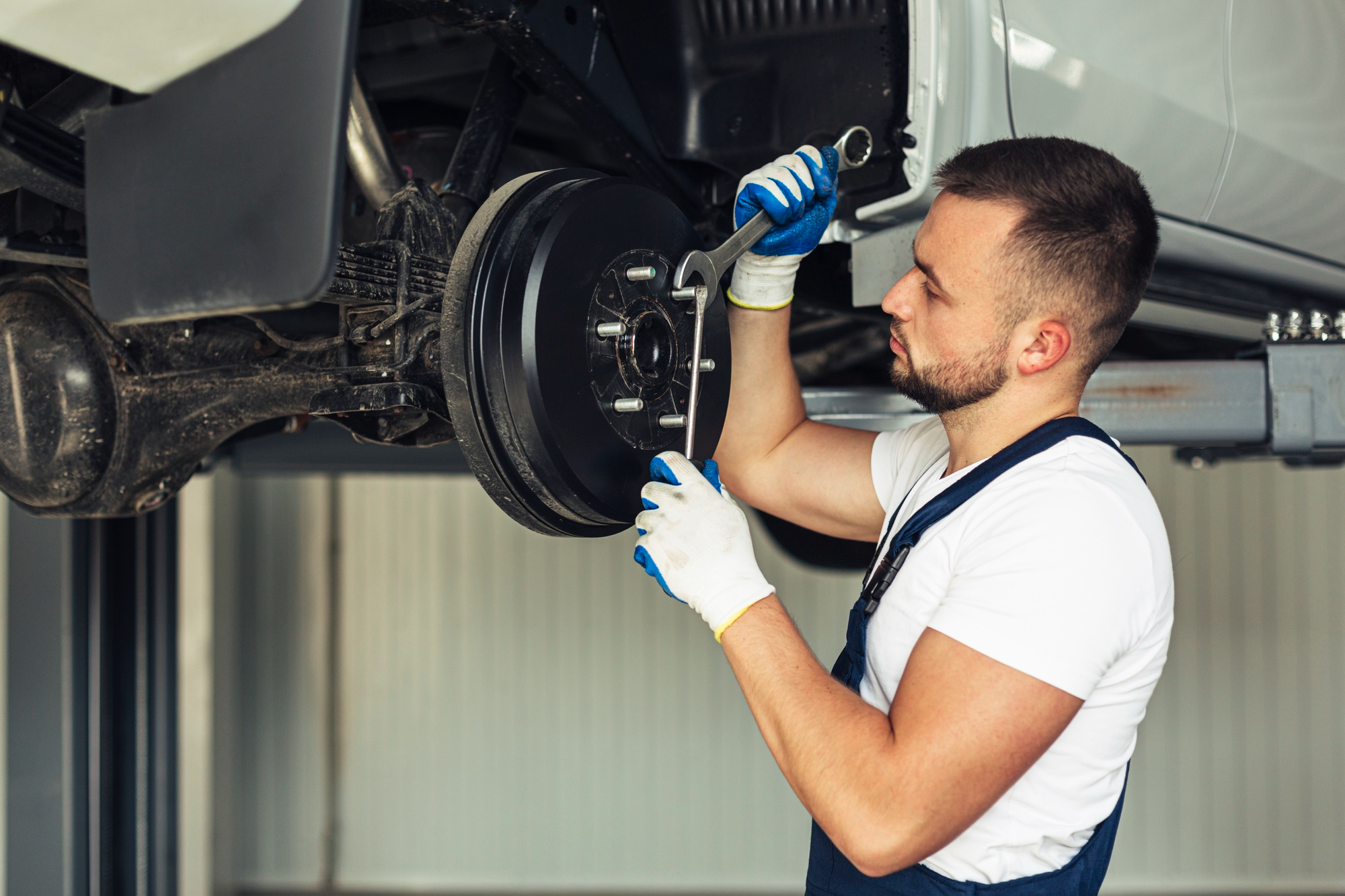 Professional mechanic repairing car shocks